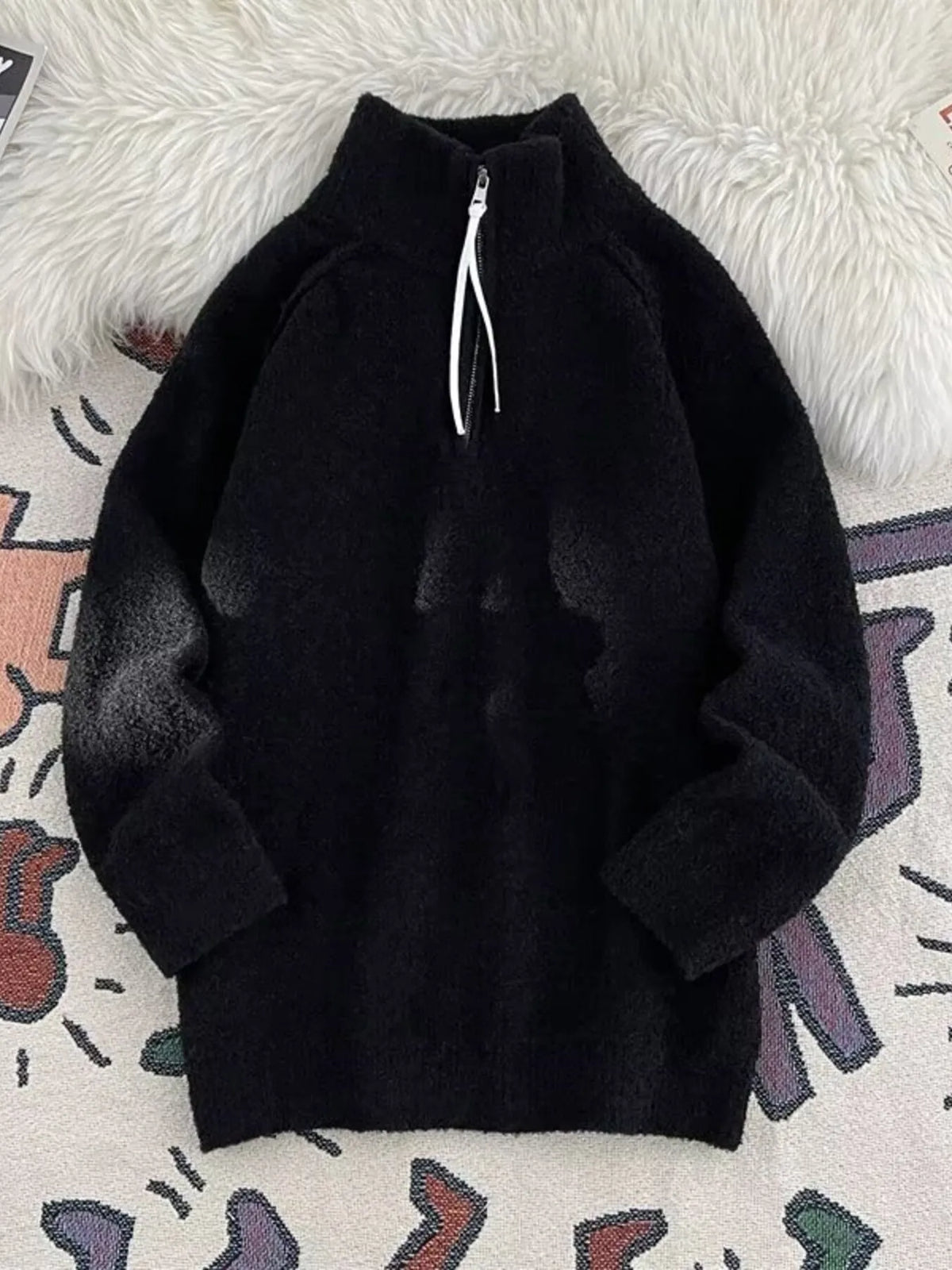 Men's black half-zip sweater with high neck and fuzzy texture.