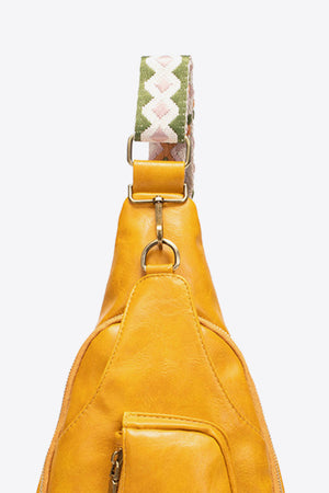 Yellow textured sling bag with woven strap detail and gold hardware.
