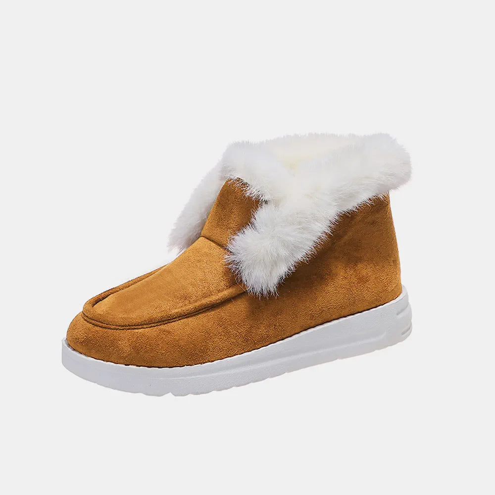 Brown suede slip-on booties with white shearling lining and trim.