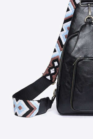 Black PU sling bag with a black strap featuring a geometric embroidered pattern in white, blue, and brown.