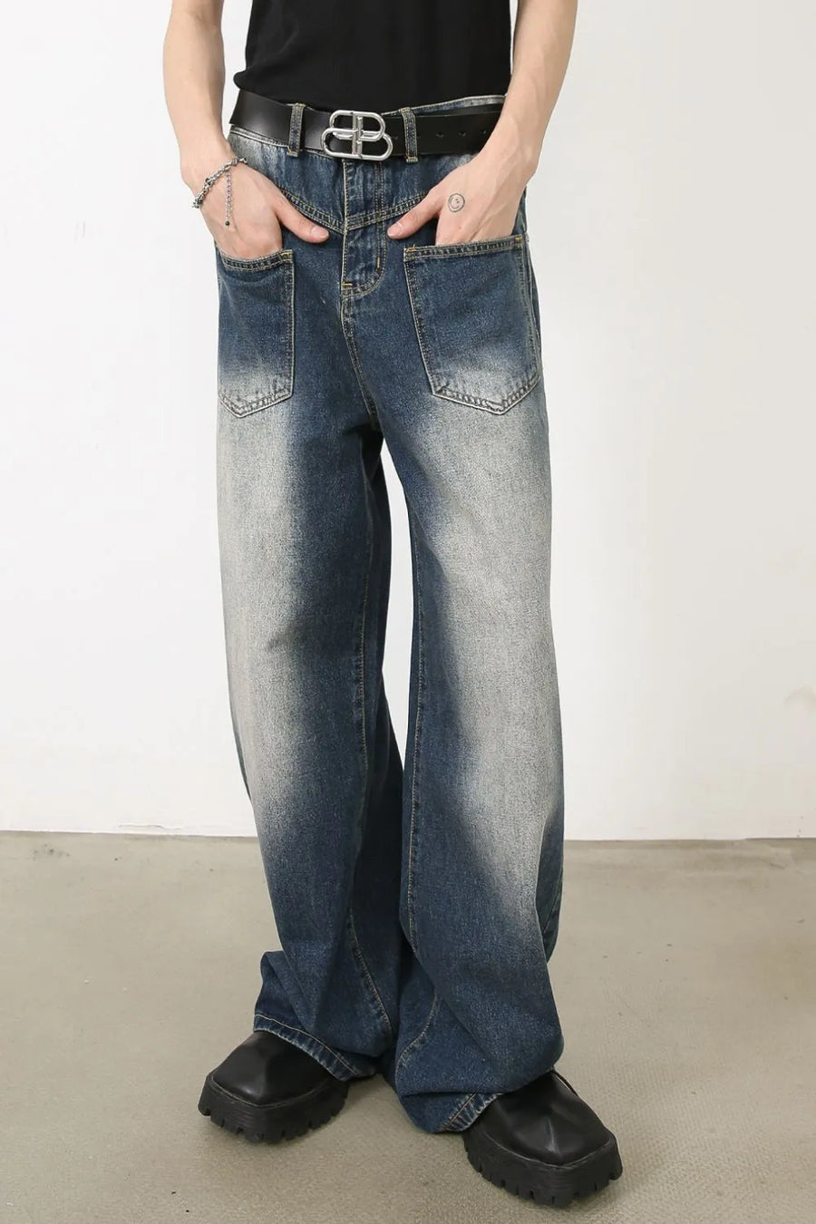 Faded wash palazzo jeans in medium blue denim with a relaxed fit and wide leg.