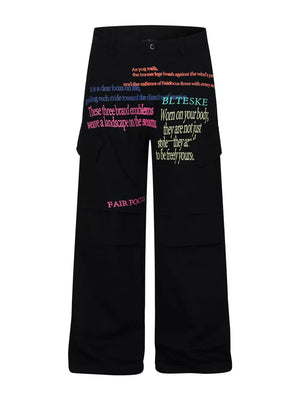 Black cargo pants with vibrant text print and multiple pockets.