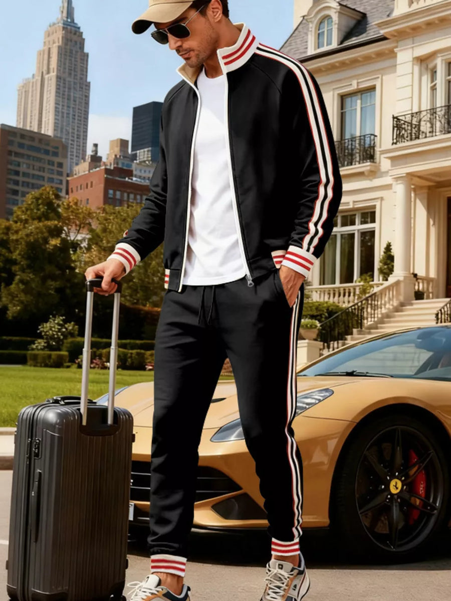 Black tracksuit with red and white stripes on sleeves and legs.