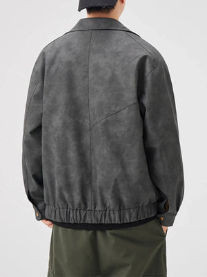 Dark gray vintage leather jacket with chevron detail and elastic hem.