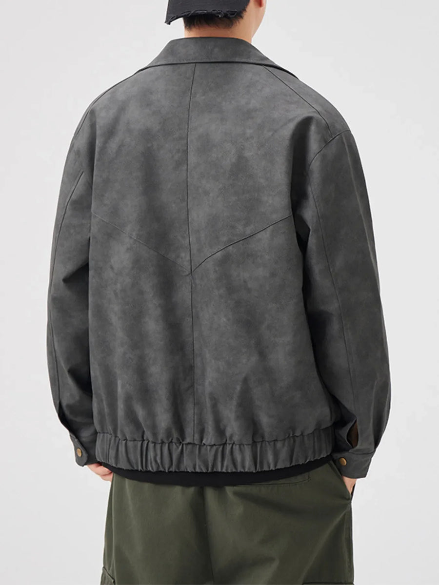 Dark gray vintage leather jacket with chevron detail and elastic hem.