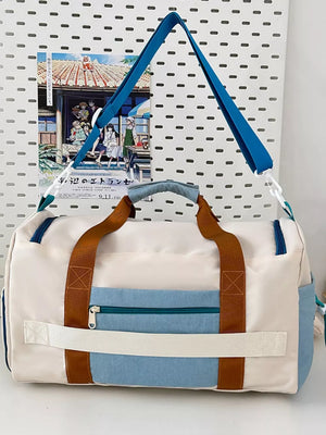 Vibrant multi-pocket nylon travel bag with color block design and brown handles.