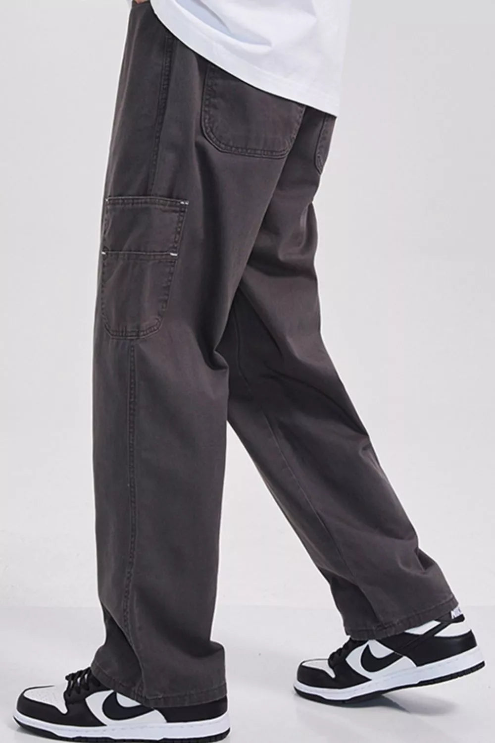 Relaxed fit dark gray cargo sweatpants with utility pockets and a casual cut.