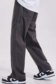 Relaxed fit dark gray cargo sweatpants with utility pockets and a casual cut.
