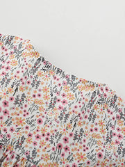 Toddler cotton dress with a whimsical floral print, ruffle sleeves, and button front detail.