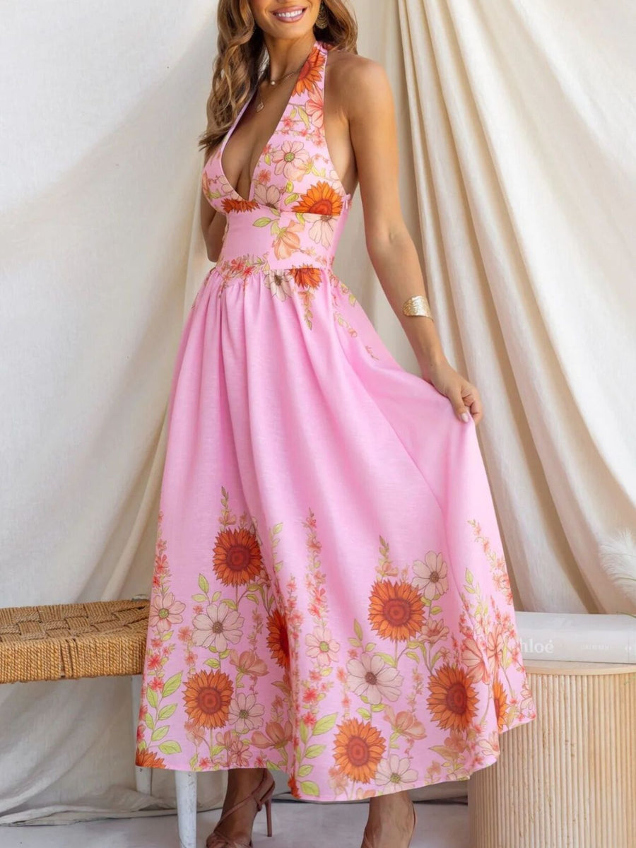 Pink floral halter neck maxi dress with a deep V-neck and flowing skirt.