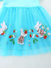 Blue tulle baby dress with embroidered bunnies and strawberries.