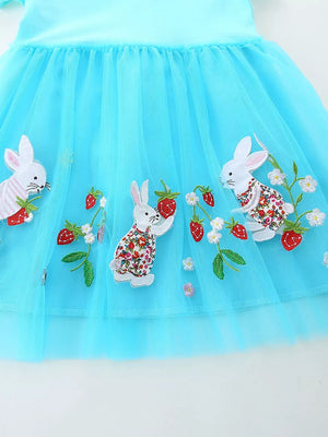 Blue tulle baby dress with embroidered bunnies and strawberries.