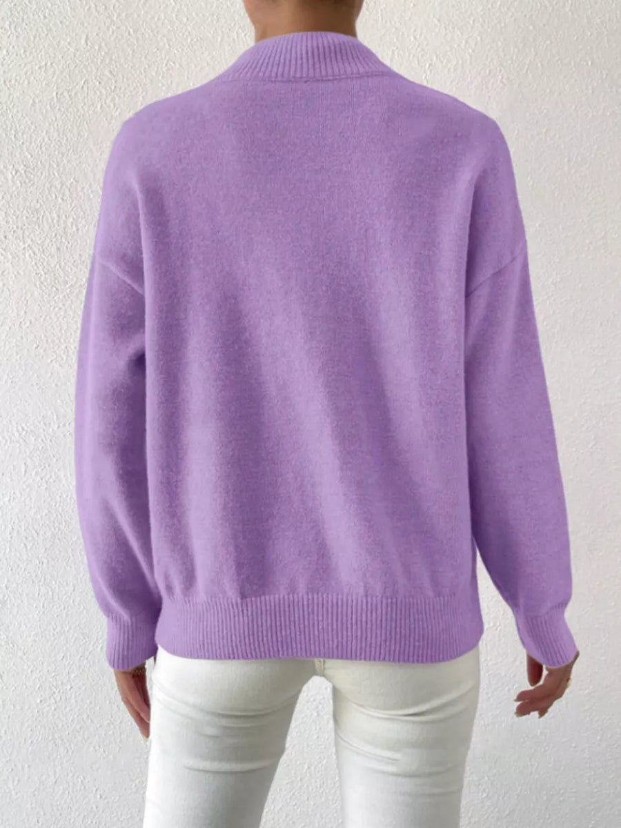 Lavender mock neck knit sweater with dropped shoulders, ribbed cuffs and hem.