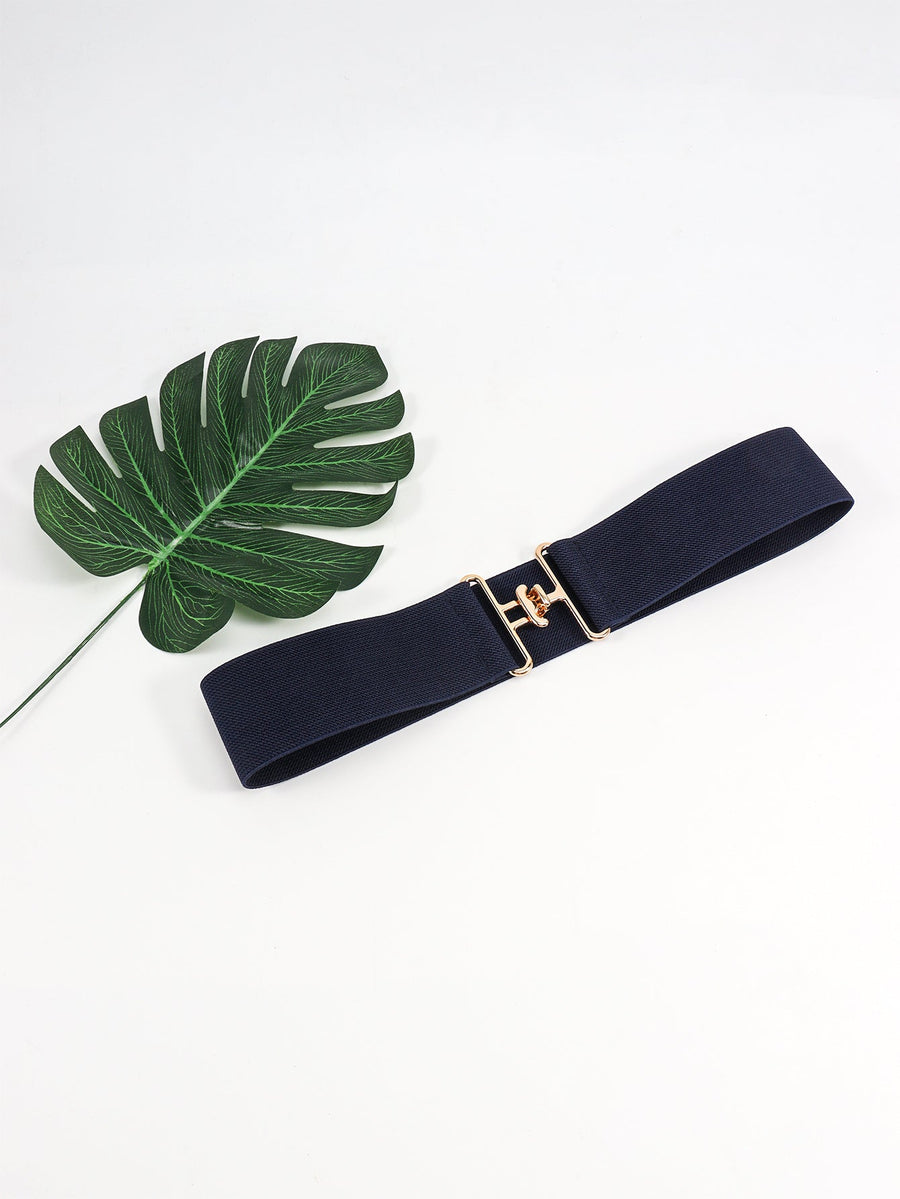Dark blue elastic belt with sculpted gold buckle and a decorative leaf.
