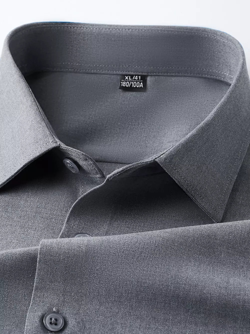Refined slim fit dark gray long sleeve men's button-down undershirt detail.