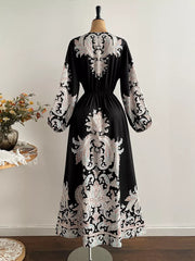 Black maxi dress with paisley print, V-neck, and balloon sleeves.