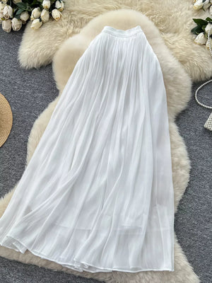 White pleated maxi skirt with a flowy, comfortable fit.