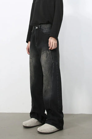 Faded wash dark wide leg denim jeans with distressed details.