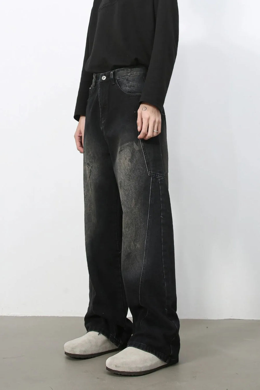 Faded wash dark wide leg denim jeans with distressed details.