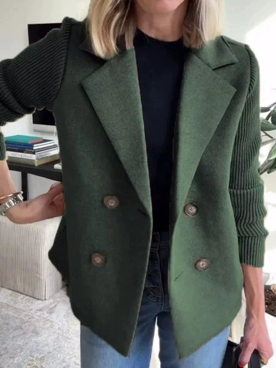 Double-breasted dark green knit sleeve outerwear with button detail.