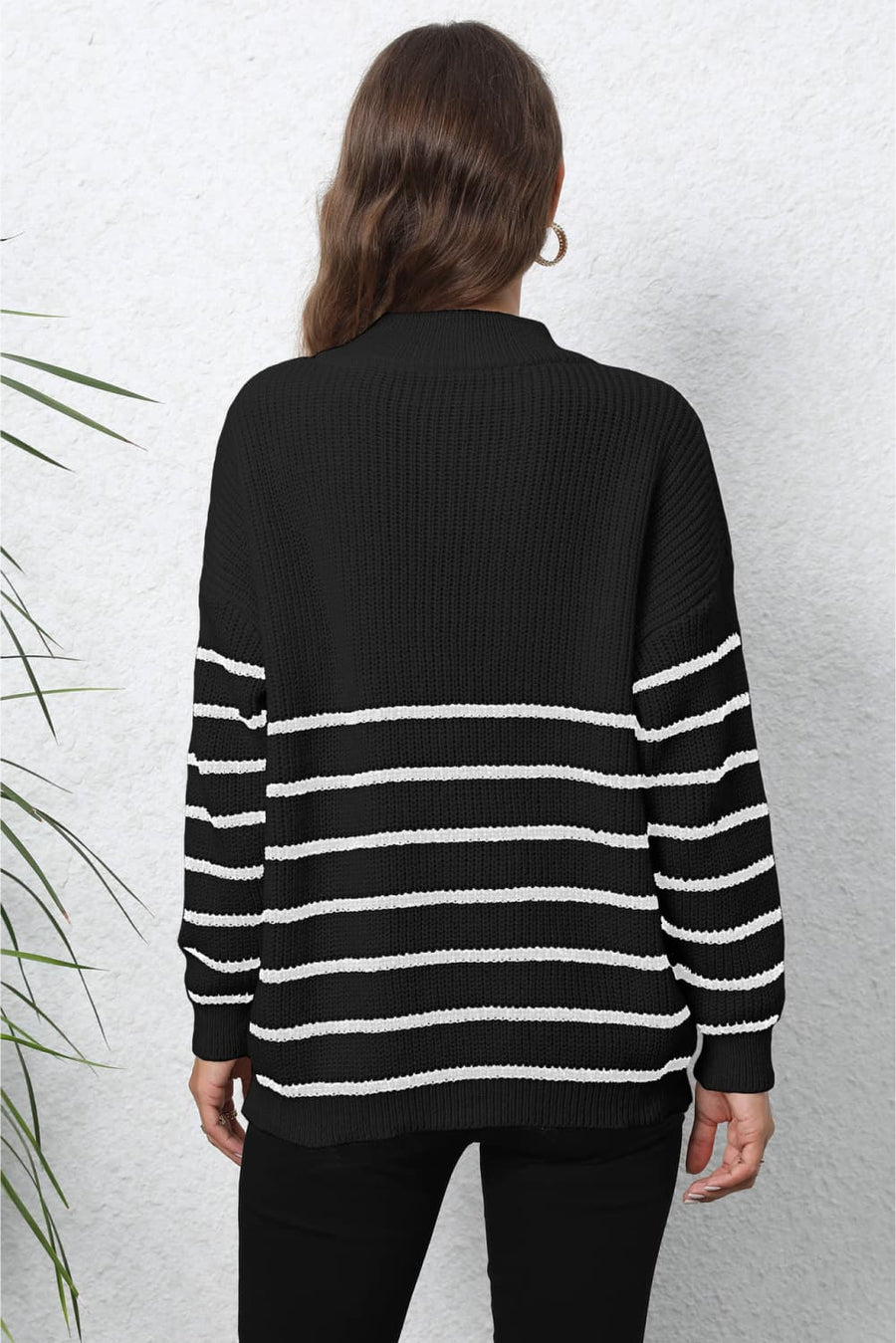 Black and white striped knit sweater with a mock neck and zip detail.