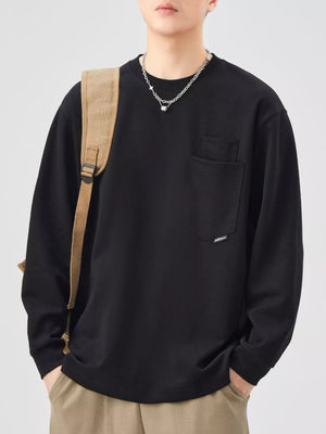 Black long-sleeve sweatshirt with chest pocket and relaxed fit