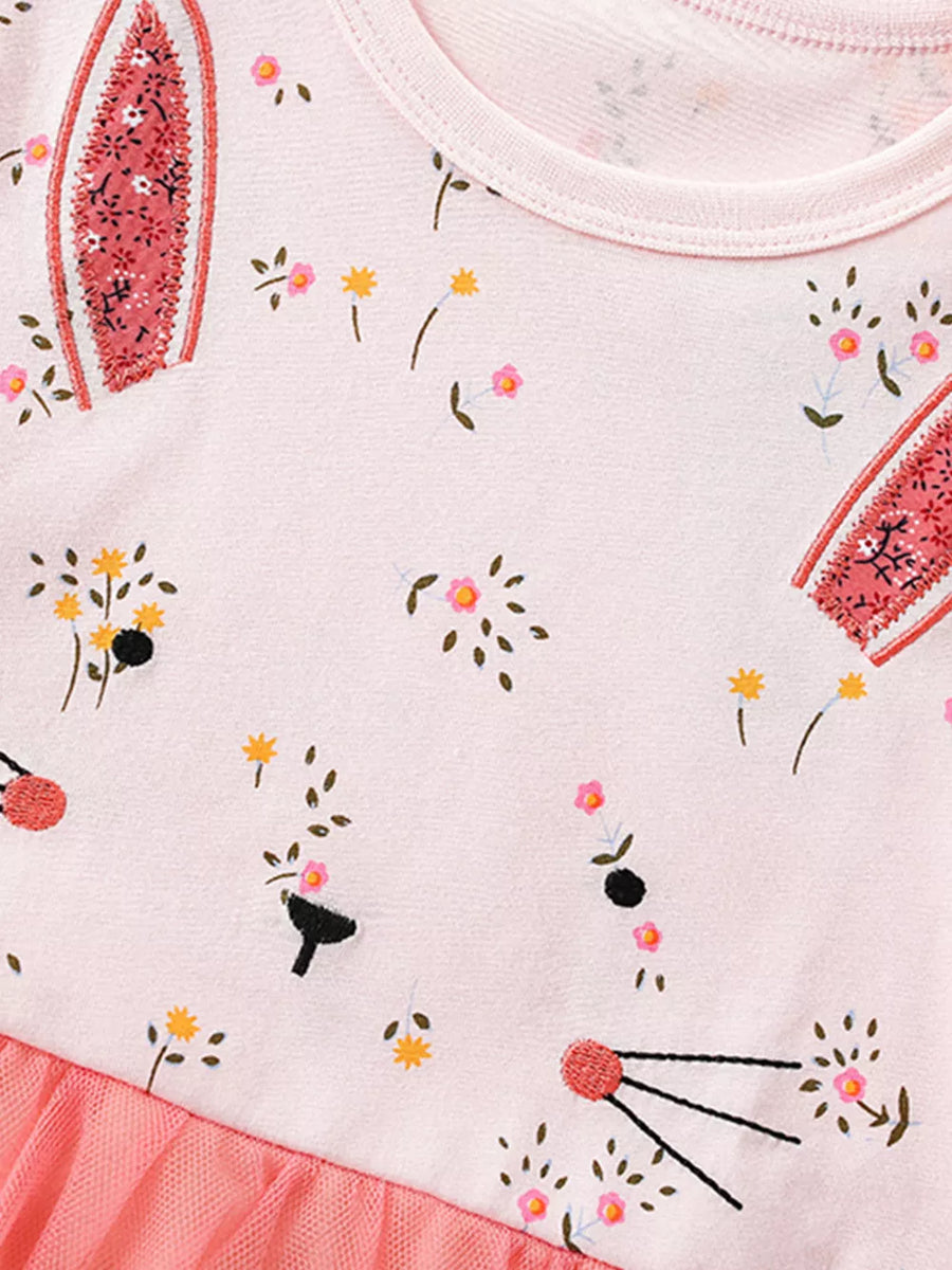 Pink cotton toddler dress with bunny face, floral print, and tulle skirt detail.