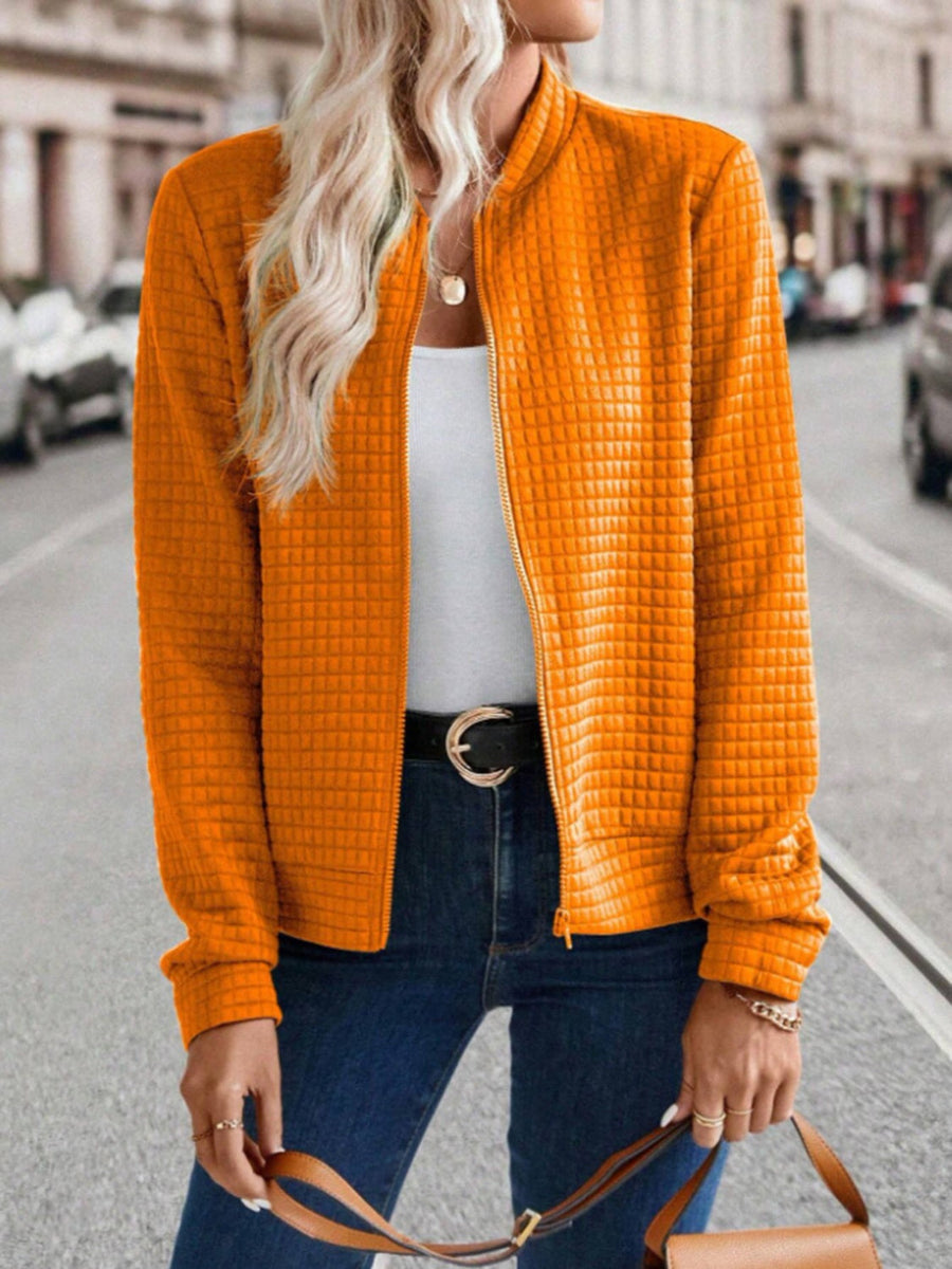 Quilted bomber jacket in Tangerine with zip closure and textured pattern.