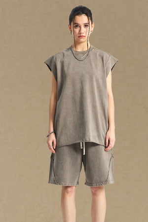Raw edge muscle tank top in taupe with a crew neck and sleeveless cut.