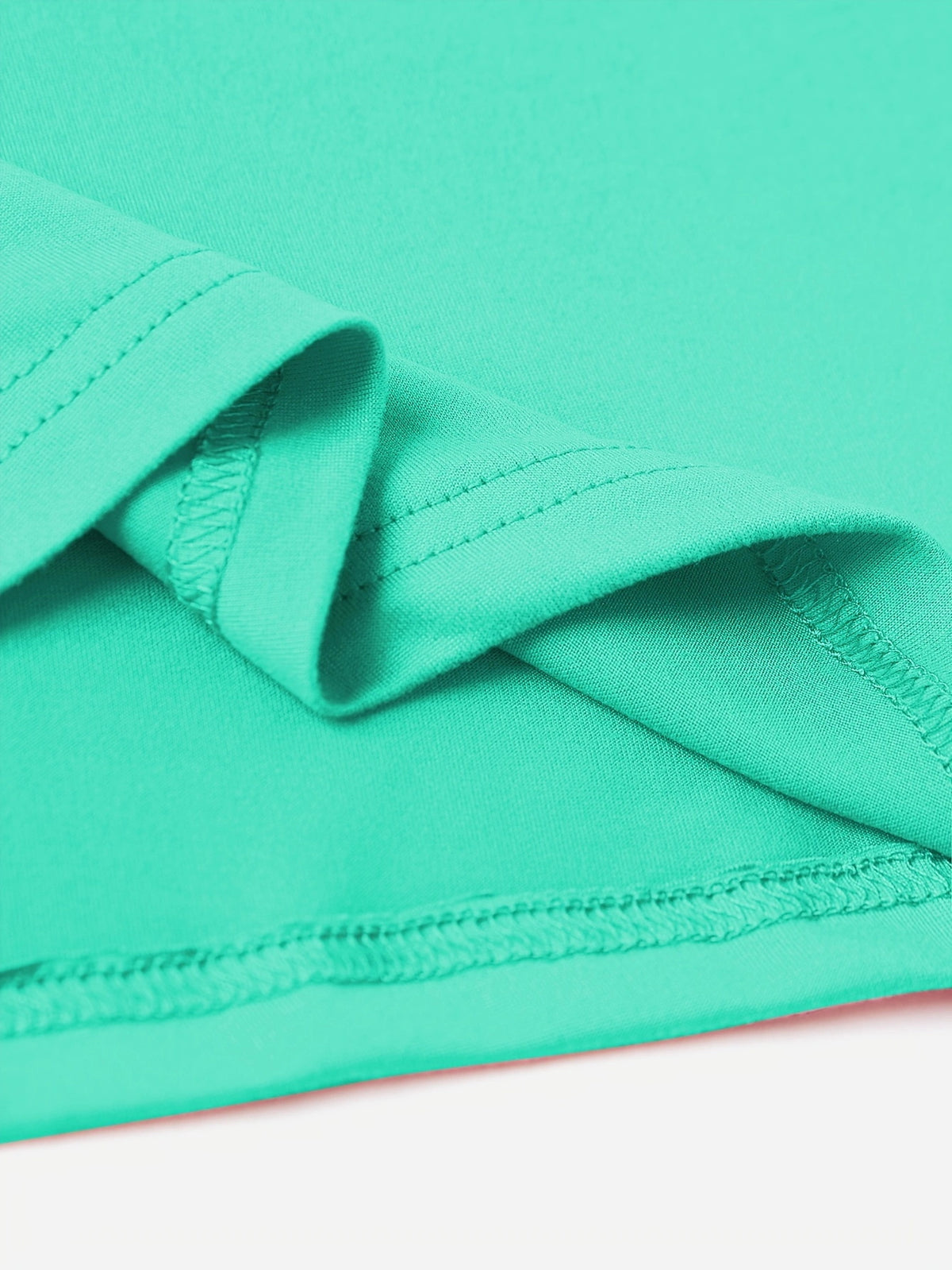 Aqua t-shirt detail showing hem and seam stitching