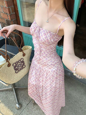Ruched tied maxi dress in pink and white plaid, with spaghetti straps and a sweetheart neckline.
