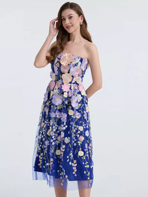 Blue midi dress with intricate floral applique and strapless neckline.