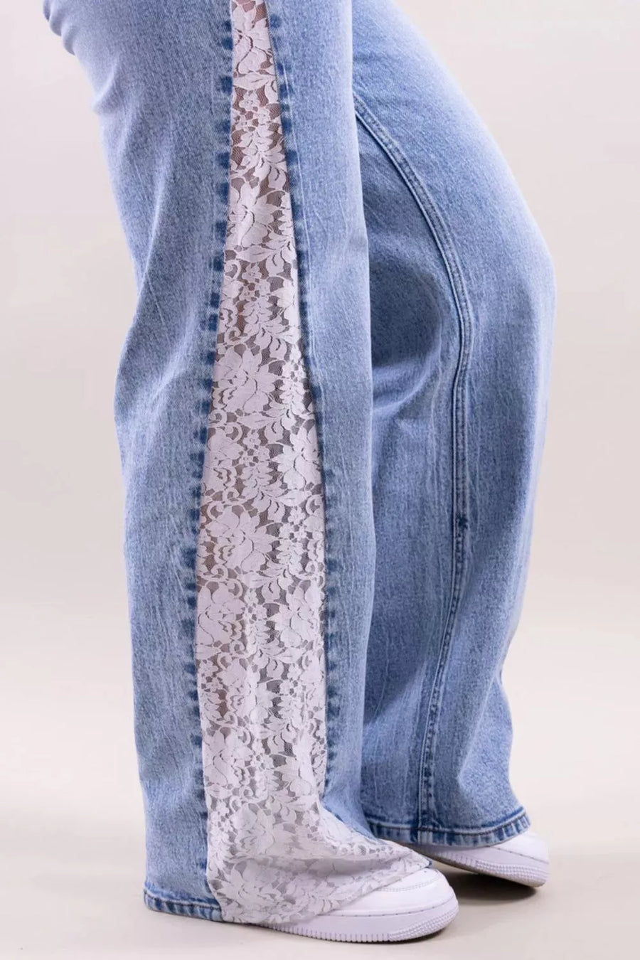 white wide-leg jeans featuring lace detail and floral