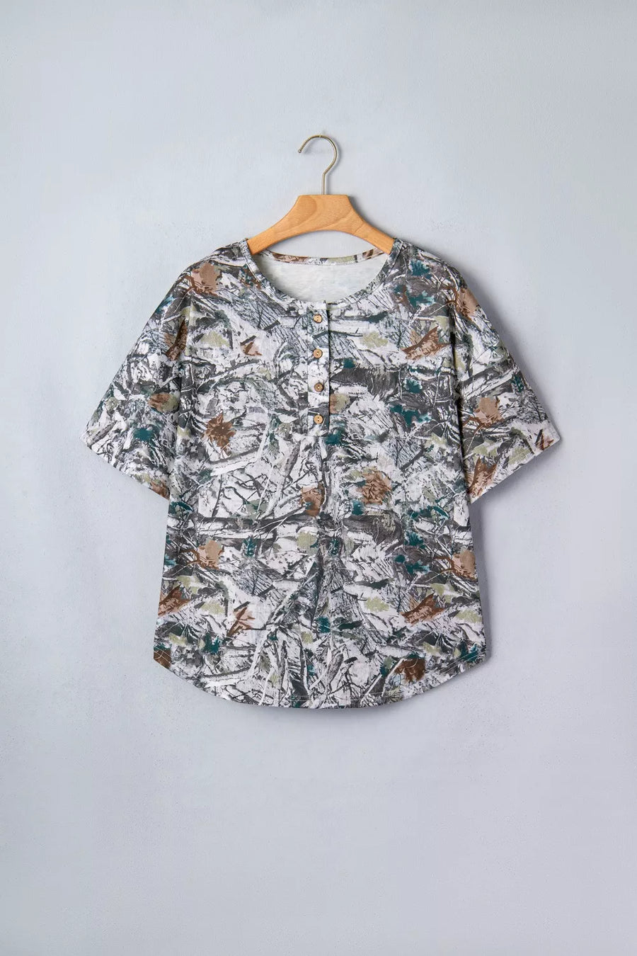 Earthy camouflage print henley t-shirt with short sleeves and buttoned placket.