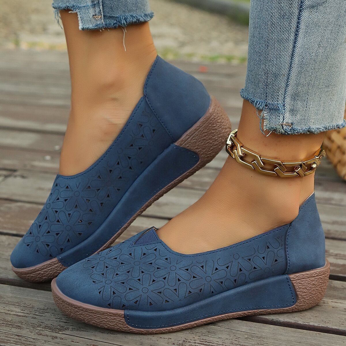 Blue floral cutout slip-on loafers with comfortable wedge sole.