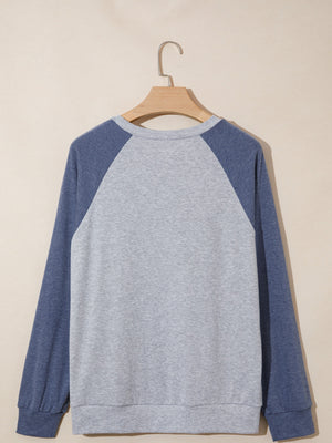 Raglan sleeve shirt in grey and blue with crew neck and cuffed sleeves.