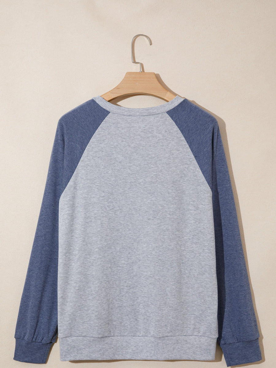 Raglan sleeve shirt in grey and blue with crew neck and cuffed sleeves.
