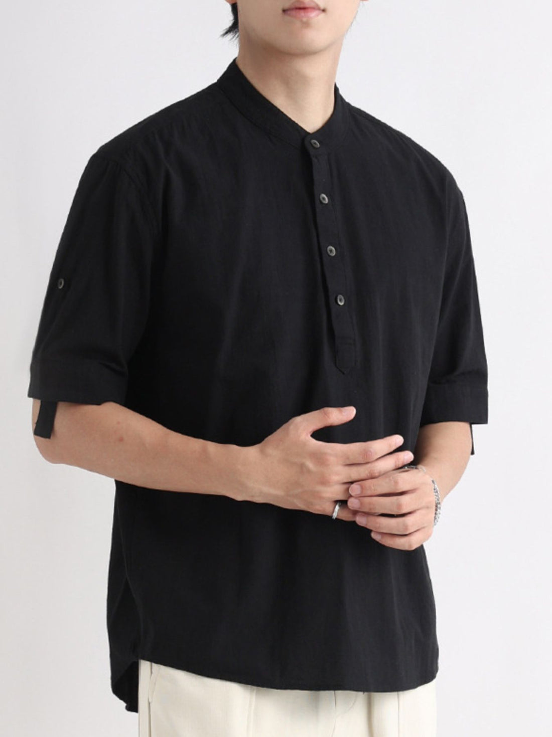 Black band collar button-down shirt with rolled sleeves.