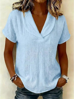 Light blue textured short sleeve blouse with a V-neck and folded collar.