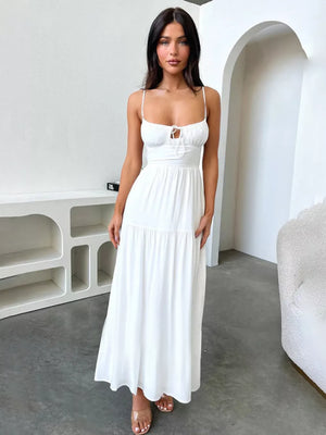 White backless maxi dress with spaghetti straps and a tie-front detail.