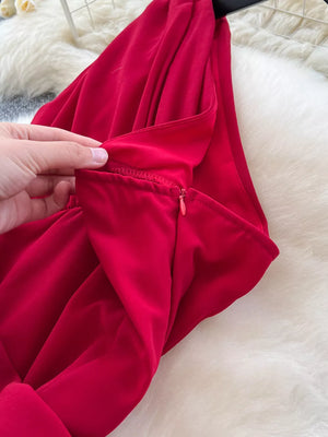 Red maternity maxi dress with one-shoulder neckline and side zipper detail.