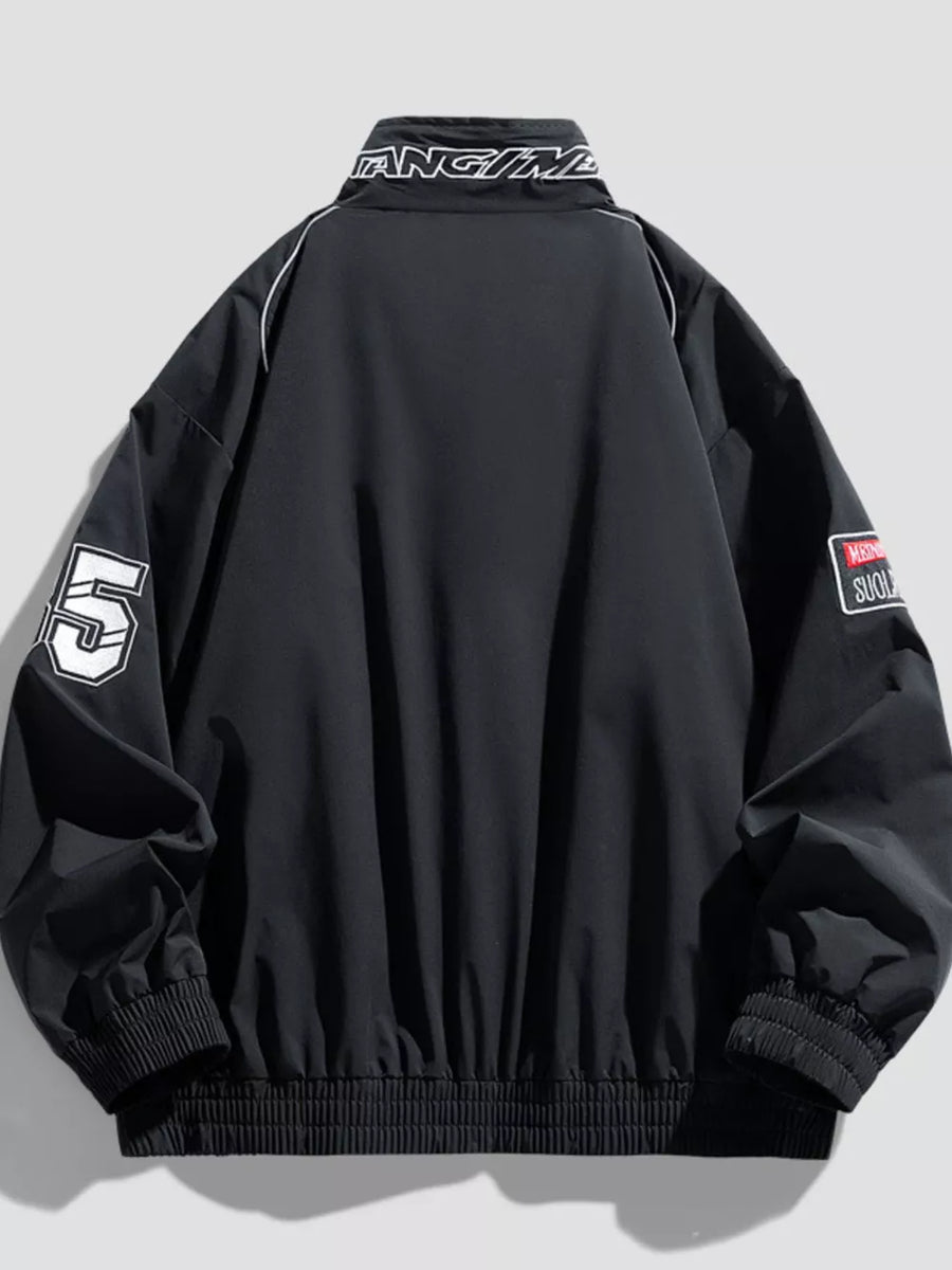 Black bomber jacket with white piping, number 5 graphic, and embroidered patches.