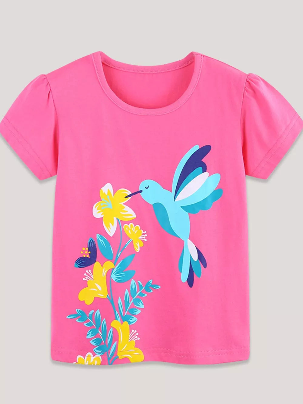 Pink t-shirt with short puff sleeves and a hummingbird and floral graphic print.
