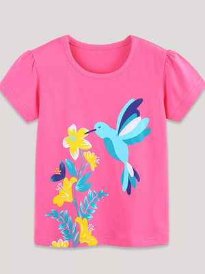Pink t-shirt with short puff sleeves and a hummingbird and floral graphic print.