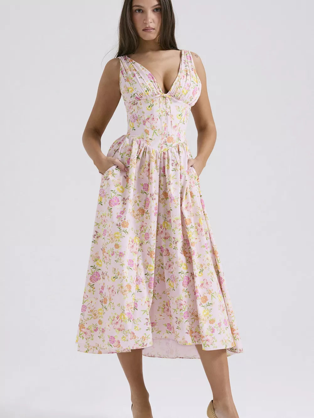 Floral print midi dress with V-neck and gathered bodice, in a light pink floral pattern.