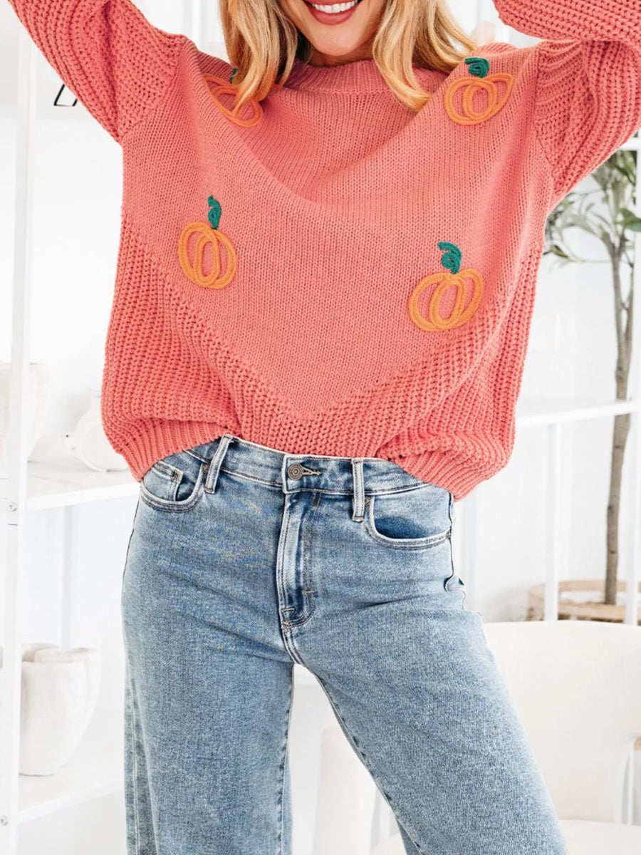 Burnt Coral knit sweater with embroidered pumpkins and a V-neck detail.