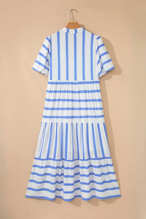 Tiered dress with blue and white stripes, short sleeves, and ruffled hem.