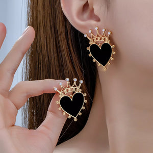 Black heart crown stud earrings with gold trim and white accents.
