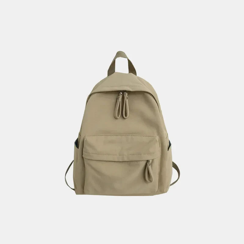 Khaki canvas school backpack with dual front pockets and zipper closure.