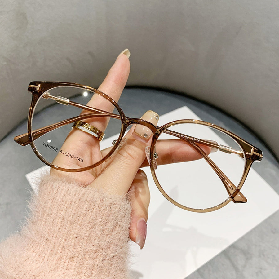 Translucent caramel round frame eyeglasses with gold accents.